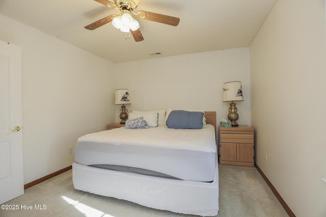 bedroom with light colored carpet, ceiling fan, visible vents, and baseboards