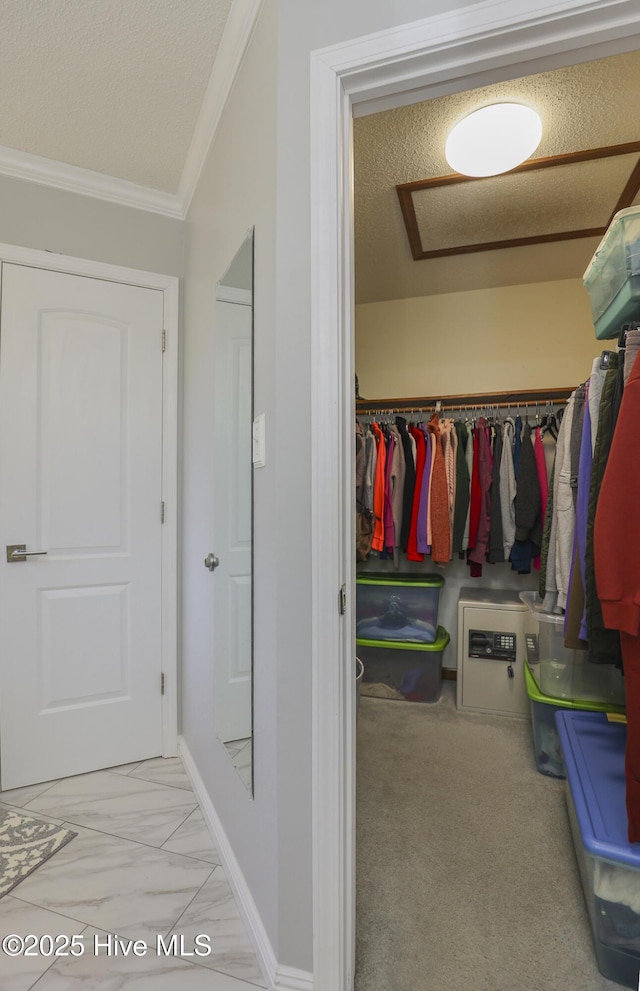 spacious closet with marble finish floor