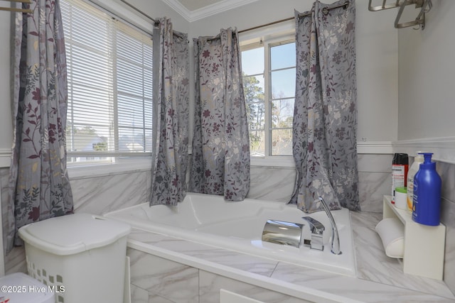 full bath with plenty of natural light, a garden tub, and crown molding