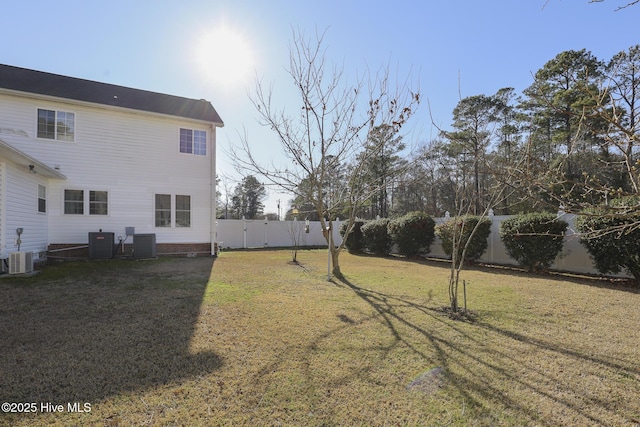 view of yard with central AC and a fenced backyard