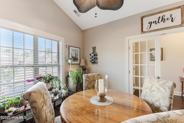 dining space featuring lofted ceiling, visible vents, a ceiling fan, and wood finished floors