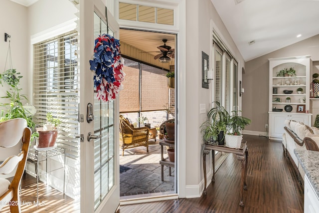 entryway with vaulted ceiling, french doors, dark wood-type flooring, and baseboards