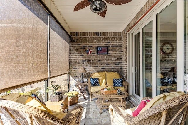 sunroom / solarium featuring a ceiling fan