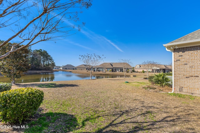 view of yard featuring a water view and a residential view