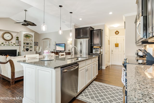 kitchen featuring white cabinetry, a kitchen island with sink, appliances with stainless steel finishes, and open floor plan