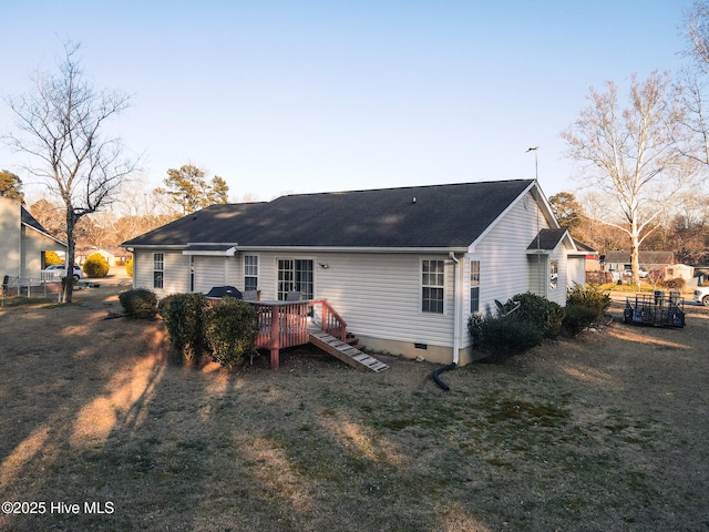 back of property featuring crawl space, fence, a deck, and a yard