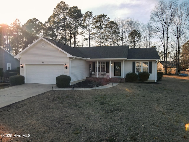 ranch-style house featuring a garage, driveway, and a front lawn