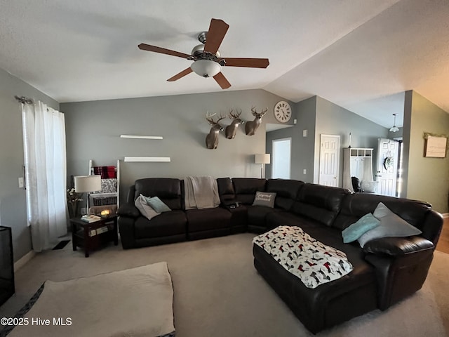 living room featuring lofted ceiling, carpet, and plenty of natural light