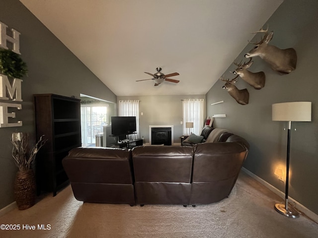 living room featuring high vaulted ceiling, a ceiling fan, light colored carpet, and baseboards