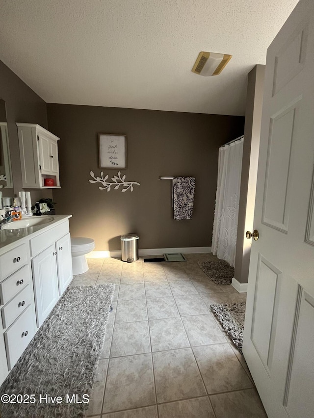 full bathroom with toilet, a shower with curtain, tile patterned floors, a textured ceiling, and vanity