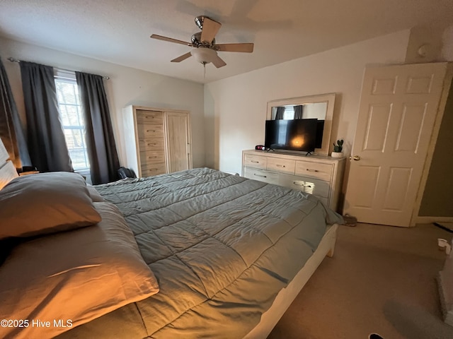 bedroom featuring ceiling fan and light colored carpet