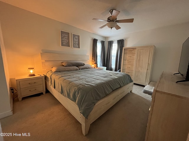 bedroom with baseboards, a ceiling fan, and light colored carpet