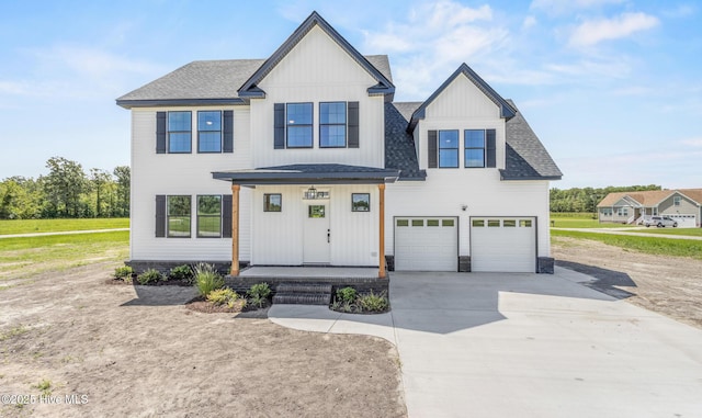 modern farmhouse with board and batten siding, concrete driveway, roof with shingles, and an attached garage