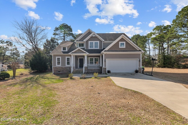 view of front facade featuring a porch, a front yard, concrete driveway, and an attached garage