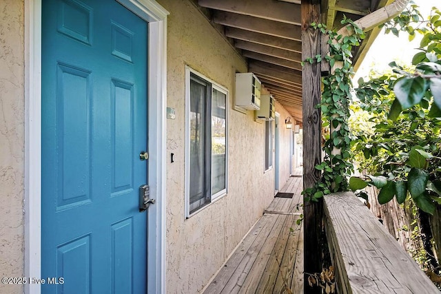 property entrance with stucco siding