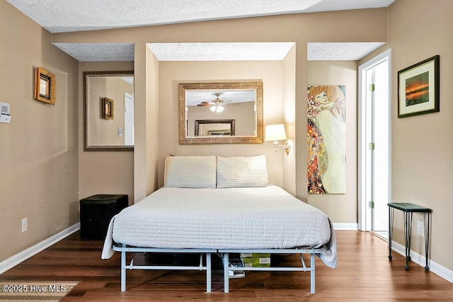 bedroom featuring baseboards and wood finished floors