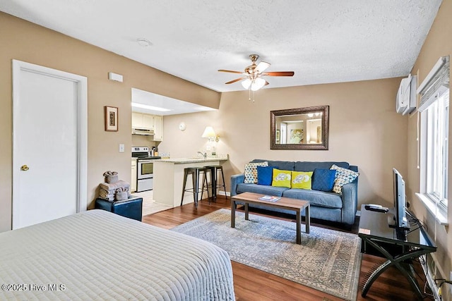 bedroom featuring a textured ceiling and wood finished floors