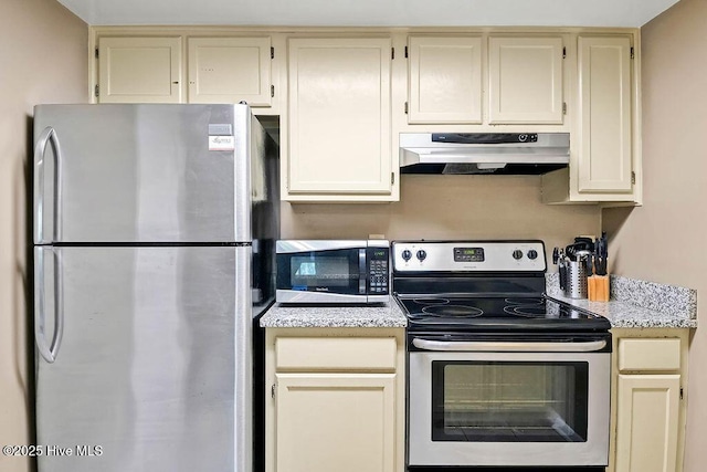 kitchen featuring appliances with stainless steel finishes, light countertops, under cabinet range hood, and cream cabinets