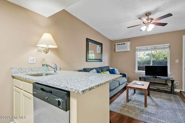 kitchen with dishwasher, light stone counters, open floor plan, a wall mounted air conditioner, and a sink