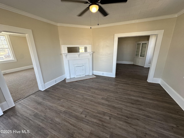 unfurnished room featuring a ceiling fan, baseboards, dark wood finished floors, and crown molding