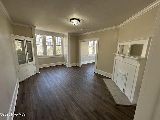 interior space with ornamental molding, a tiled fireplace, dark wood finished floors, and baseboards