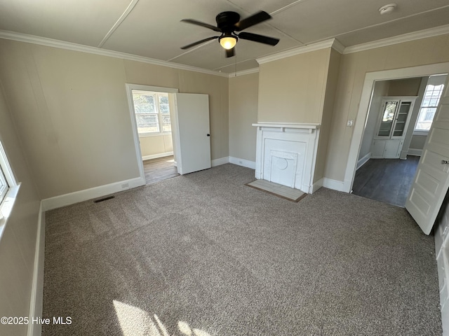 unfurnished bedroom featuring dark carpet, visible vents, crown molding, and baseboards