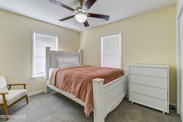 carpeted bedroom with a ceiling fan, baseboards, visible vents, and a textured ceiling