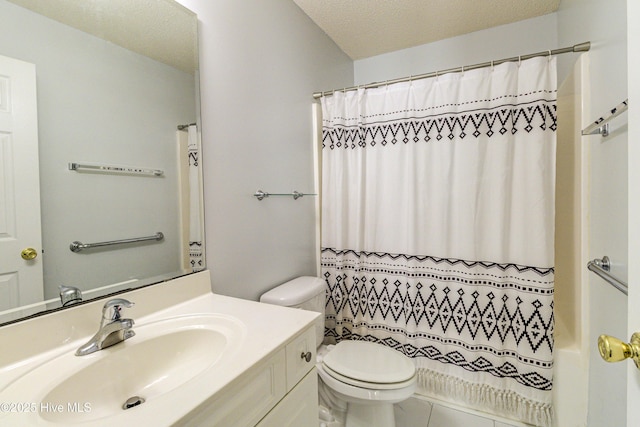 bathroom with a textured ceiling, vanity, and toilet