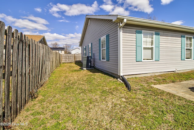 view of home's exterior featuring a yard, cooling unit, and a fenced backyard