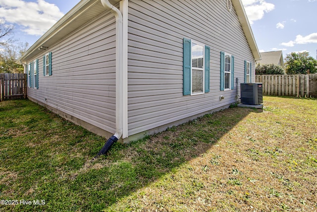 view of side of home featuring a yard, fence, and central air condition unit