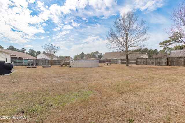 view of yard with a fenced backyard and a fenced in pool