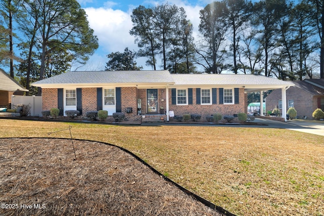 ranch-style house featuring brick siding, concrete driveway, crawl space, a carport, and a front lawn