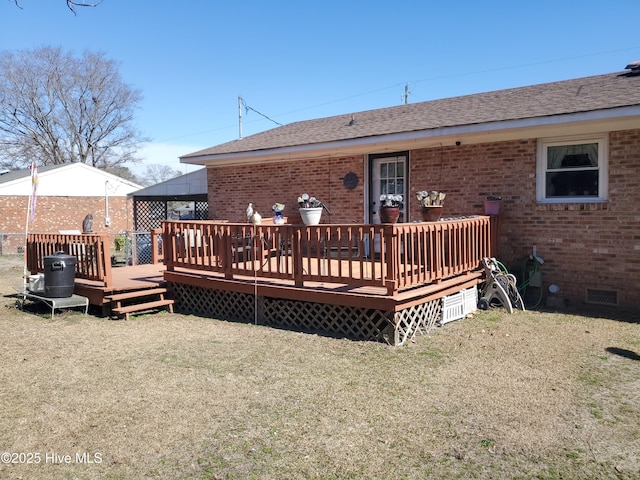 back of house with roof with shingles, brick siding, crawl space, and a wooden deck