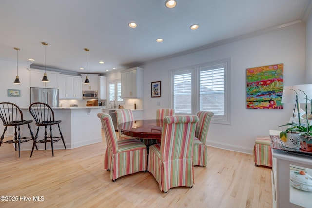 dining area featuring recessed lighting, crown molding, light wood-style floors, and baseboards