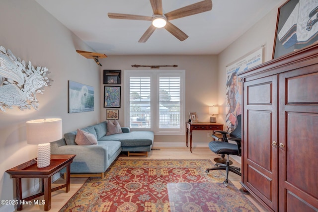office area with ceiling fan and light wood-style floors
