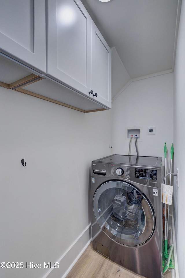 washroom featuring washer / dryer, cabinet space, wood finished floors, and baseboards