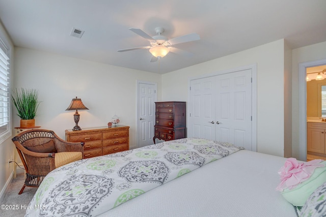 carpeted bedroom with multiple windows, a closet, and ceiling fan