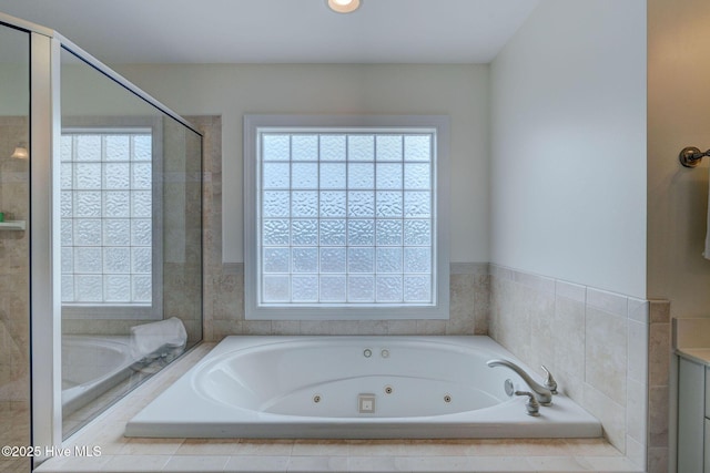 full bathroom with a jetted tub and a shower stall
