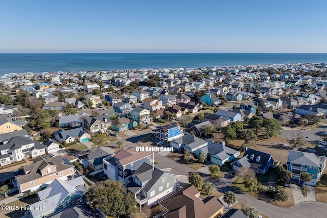 aerial perspective of suburban area with a large body of water