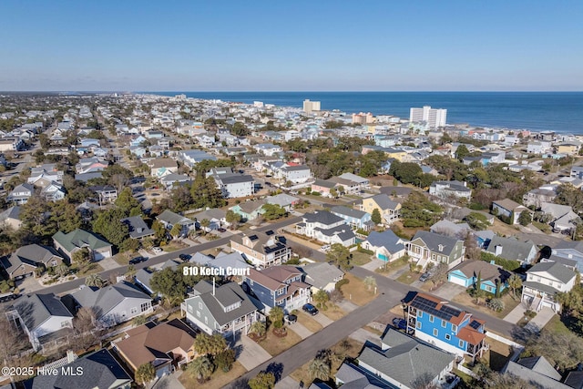 aerial overview of property's location with a large body of water and nearby suburban area