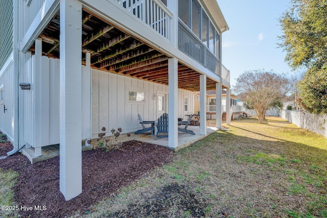 back of property with a patio and board and batten siding