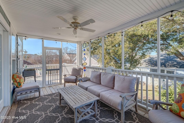 sunroom / solarium featuring an outdoor living space and ceiling fan