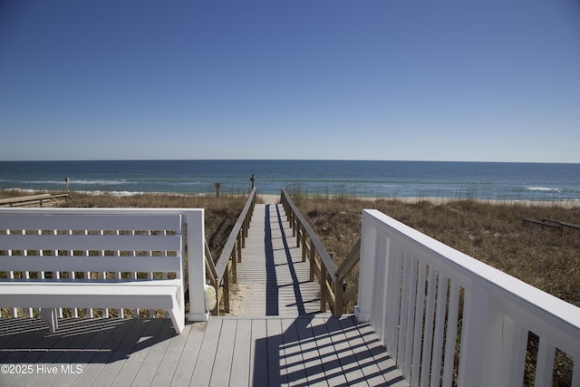 view of community featuring view of water and beach
