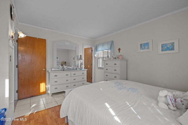 bedroom featuring light tile patterned floors and ornamental molding