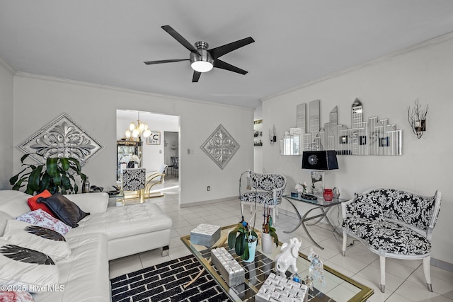 living room with ornamental molding, tile patterned flooring, baseboards, and ceiling fan with notable chandelier