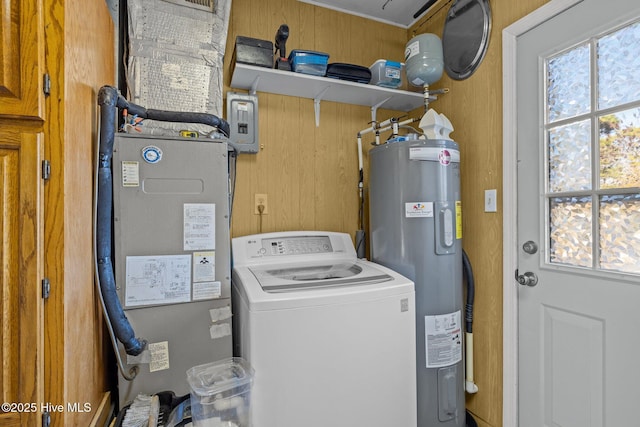 laundry area featuring electric water heater, laundry area, plenty of natural light, and washer / dryer