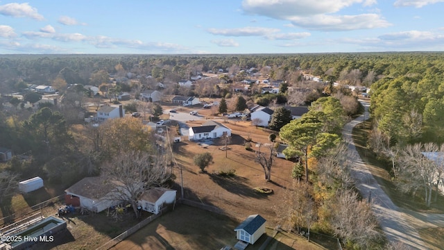 birds eye view of property featuring a wooded view