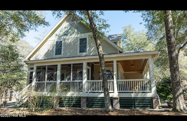 farmhouse inspired home featuring a sunroom and stairway
