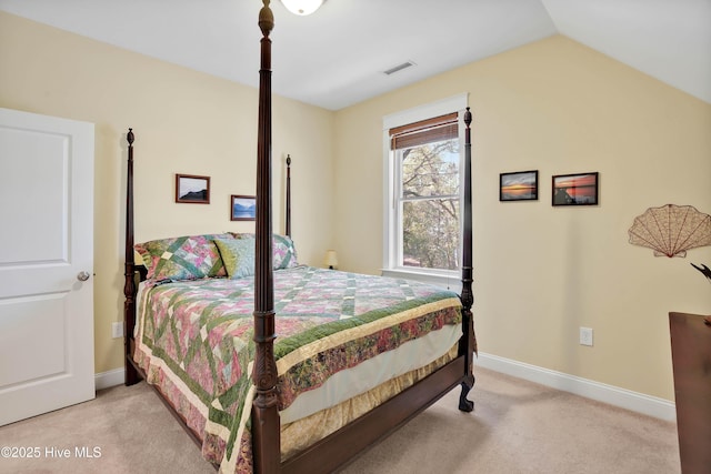 bedroom with light carpet, baseboards, visible vents, and lofted ceiling