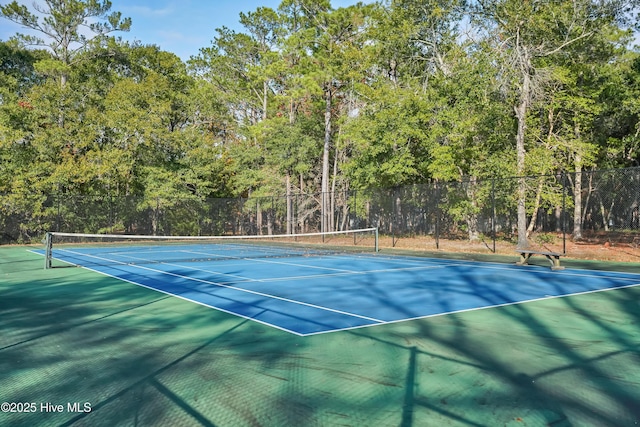 view of sport court featuring fence